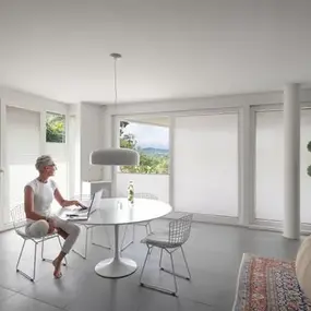 Helle, modern eingerichtete Wohnung mit großen Fenstern, Homeoffice und Pflanzen.